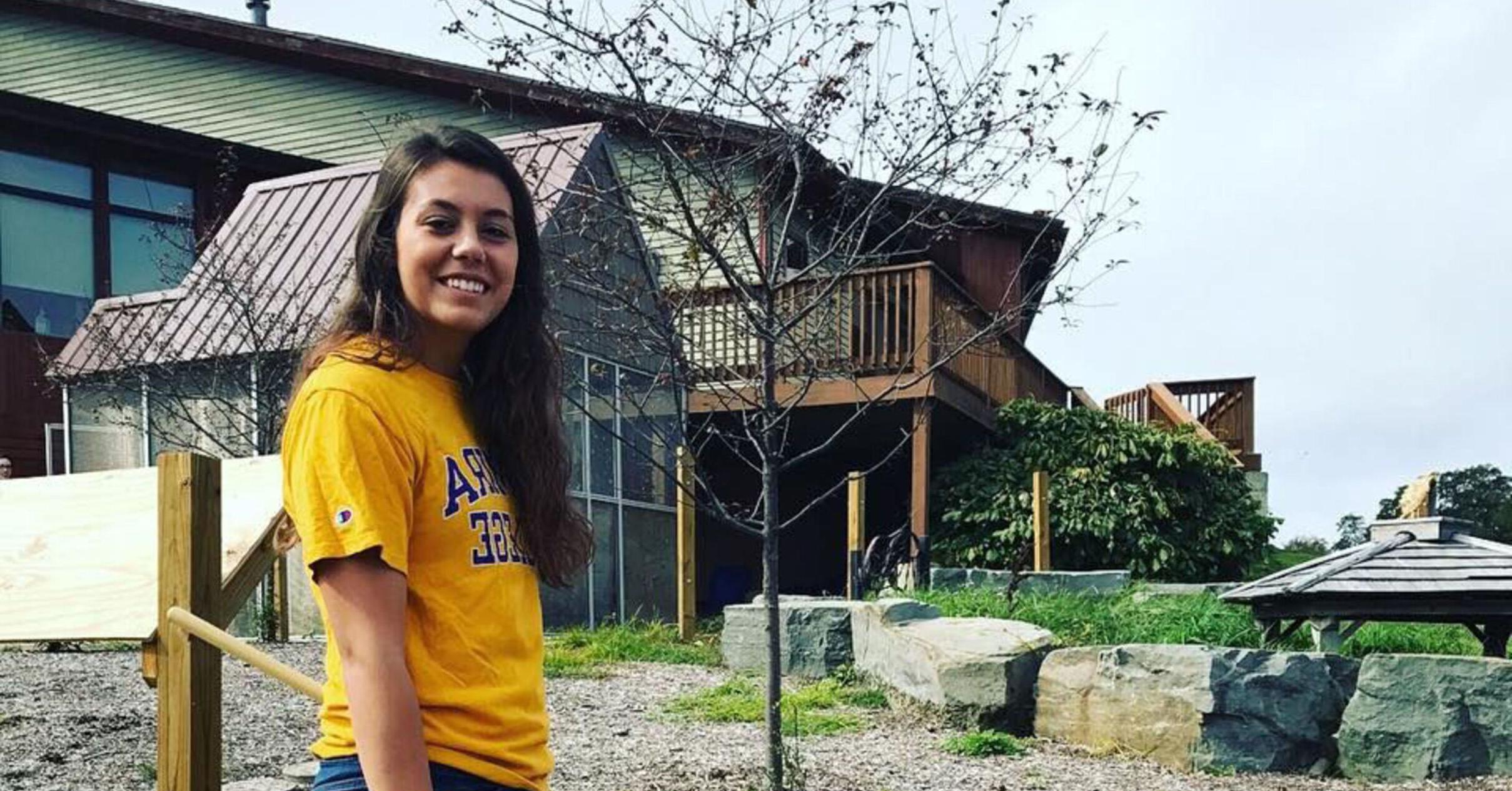 A student stands in front of the Tanglewood Nature Center